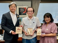 大人気の商品を手にさわたく工房の大澤進代表、大澤奈都子さんと記念撮影