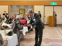 参加者へお祝いの花束を贈呈する市長